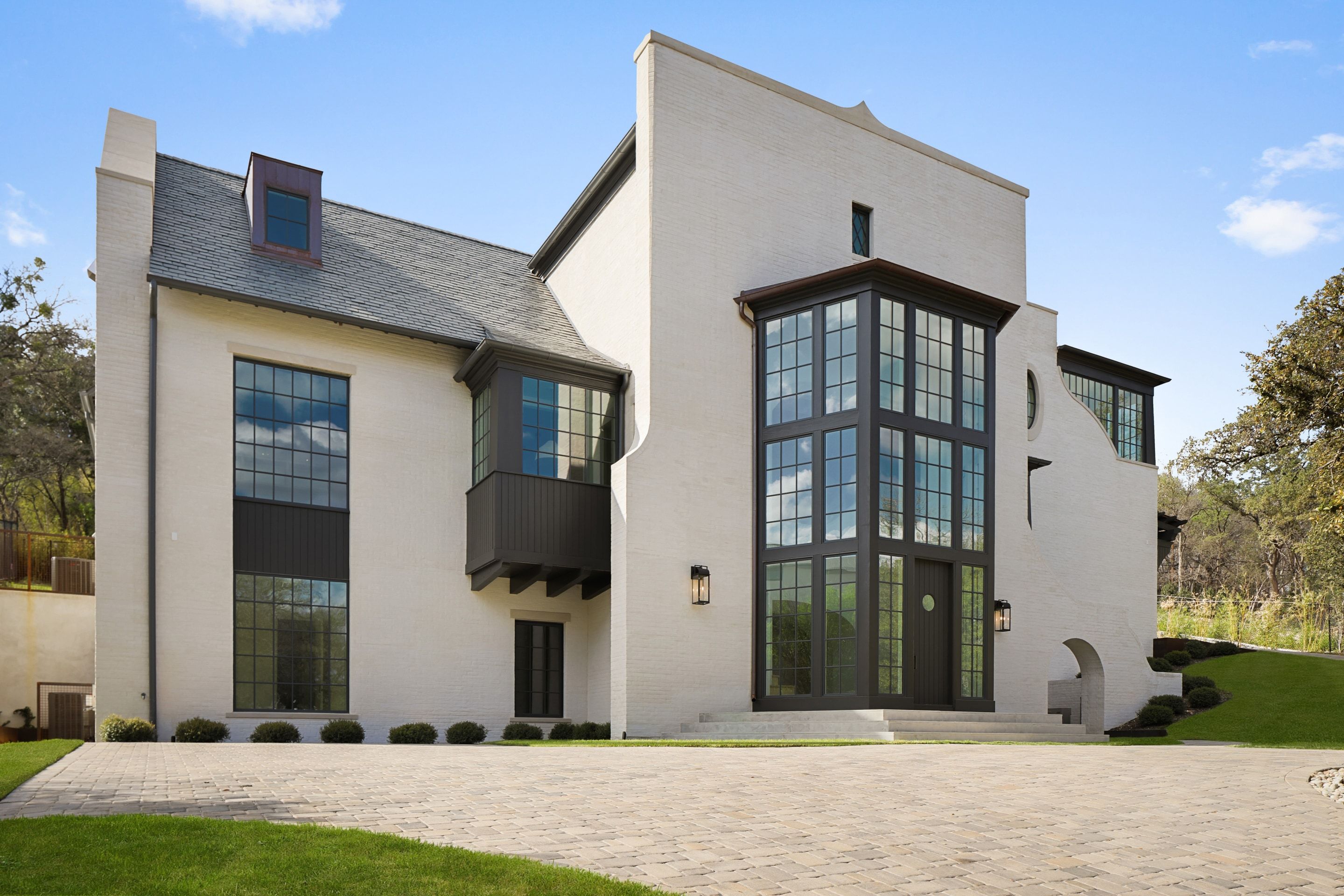 White painted brick facade with bay windows